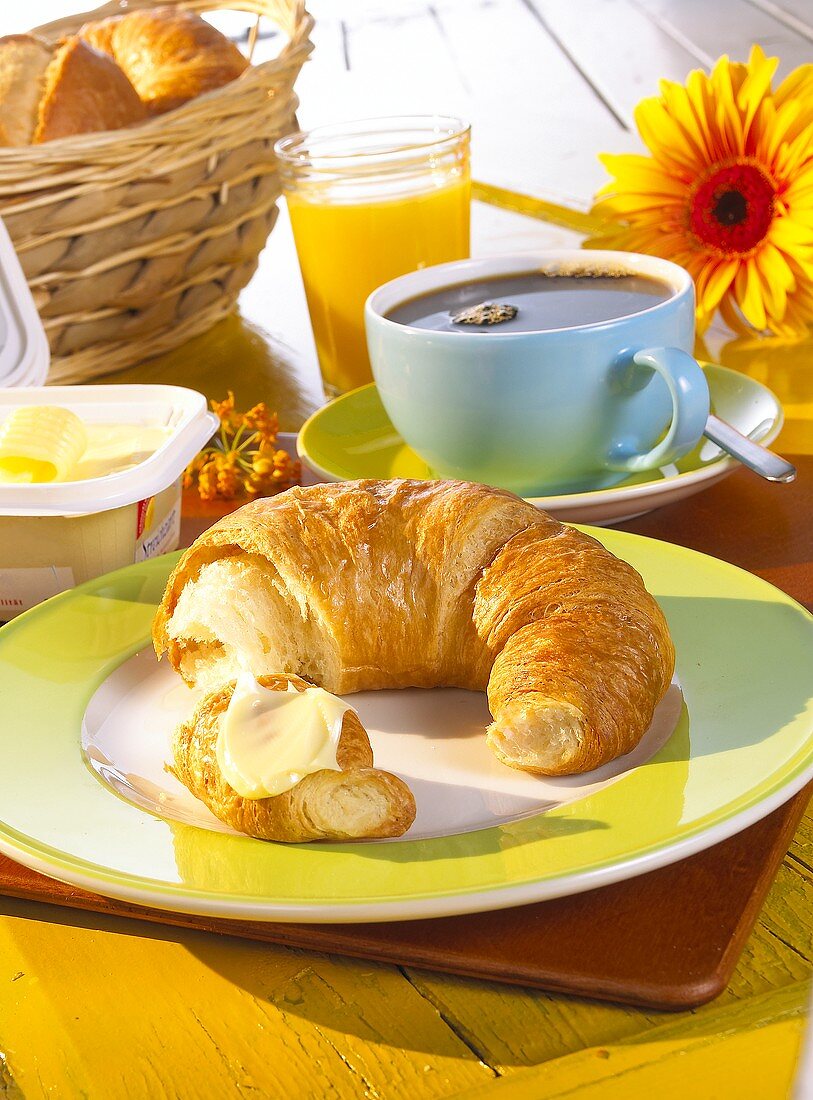 Breakfast with croissant, coffee and orange juice