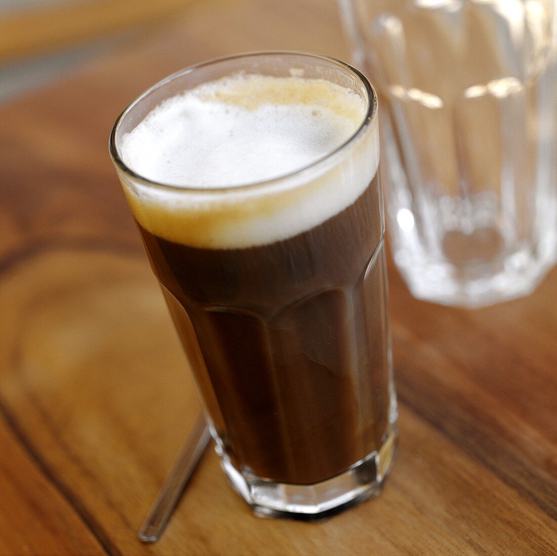 Frothy coffee in glass