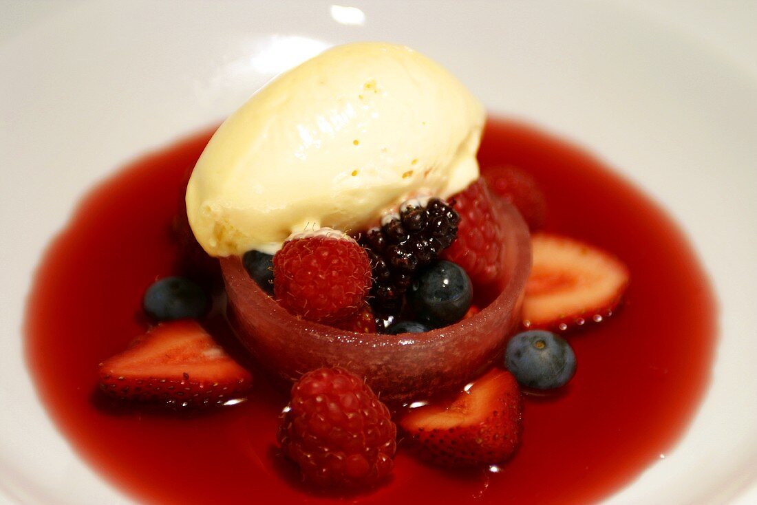 Mixed berries with fruit sauce and vanilla ice cream