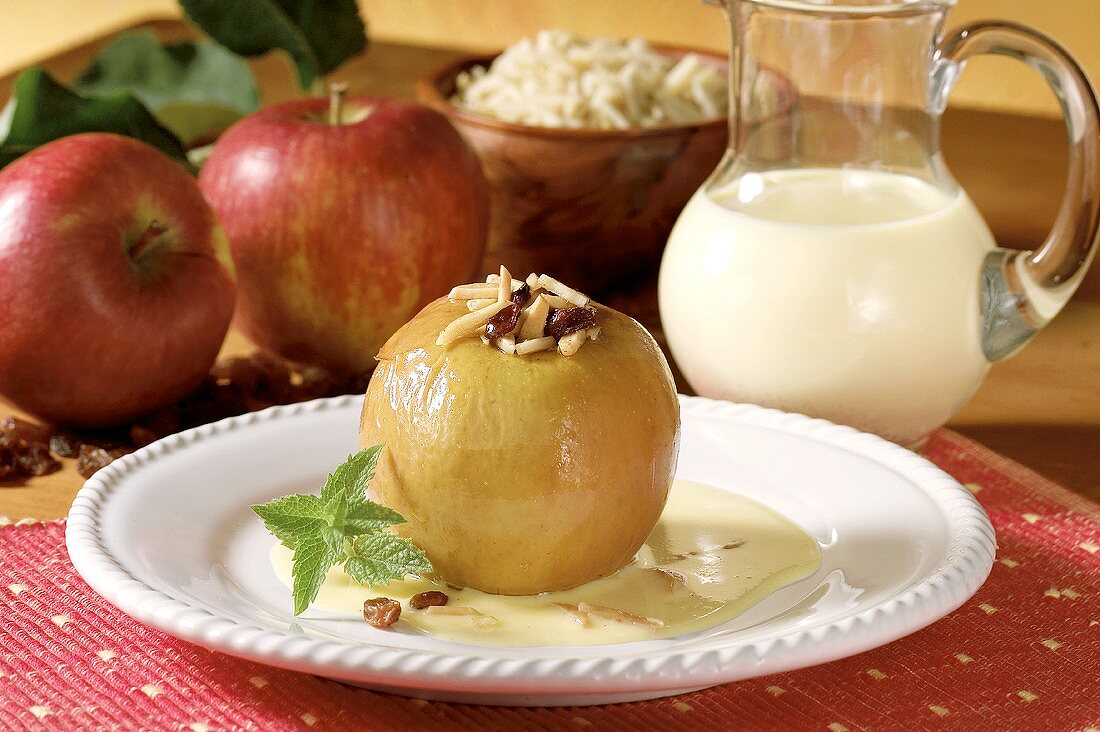 Baked apple with raisins, almonds and custard