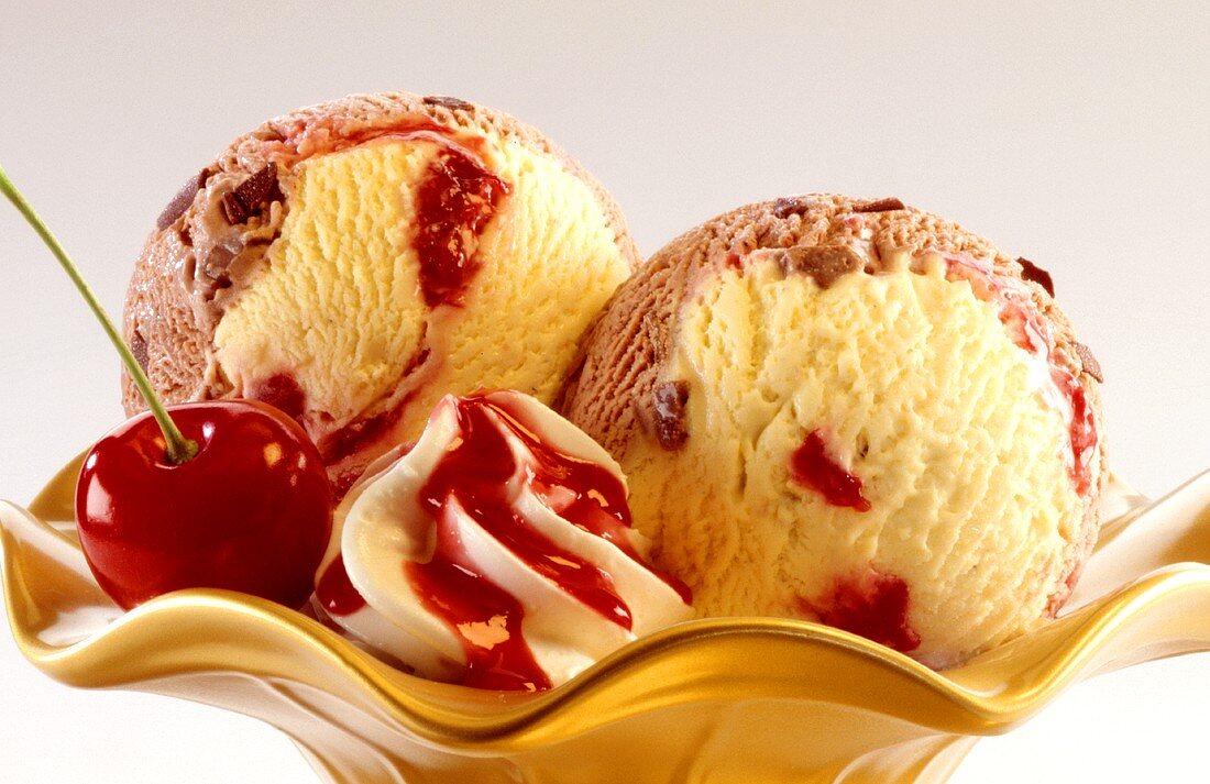 Cherry and vanilla ice cream with cream and cherry