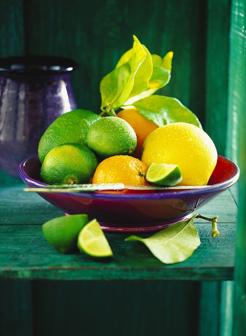 Fresh citrus fruits in red bowl