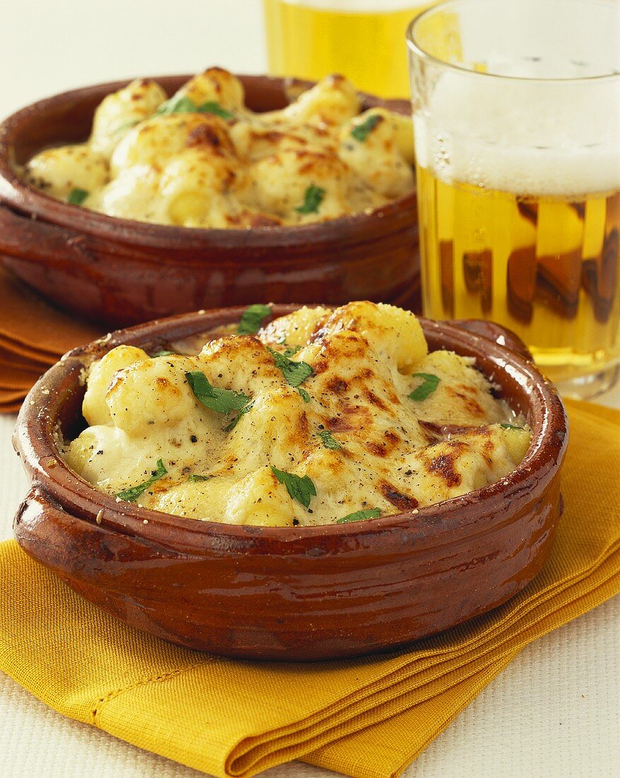 Gnocchi with cheese sauce; glass of beer
