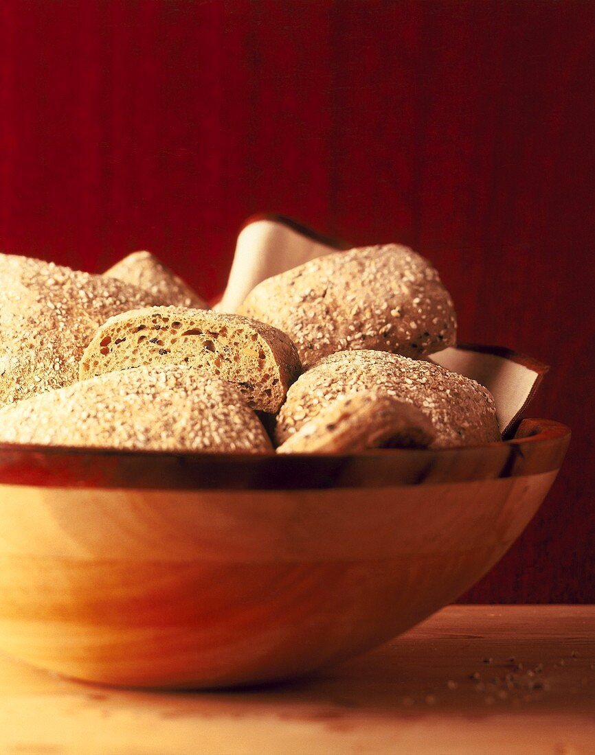 Wholemeal rolls in wooden bowl