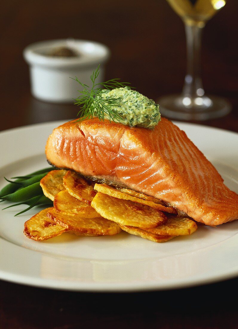 Salmon fillet with green olive cream on fried potatoes