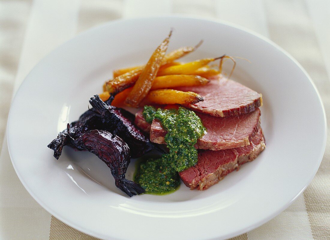 Corned beef with parsley sauce and fried vegetables