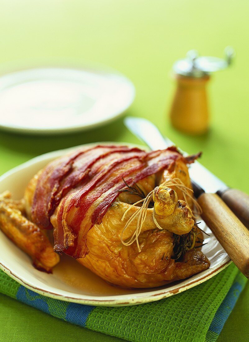 Roast chicken with slices of bacon