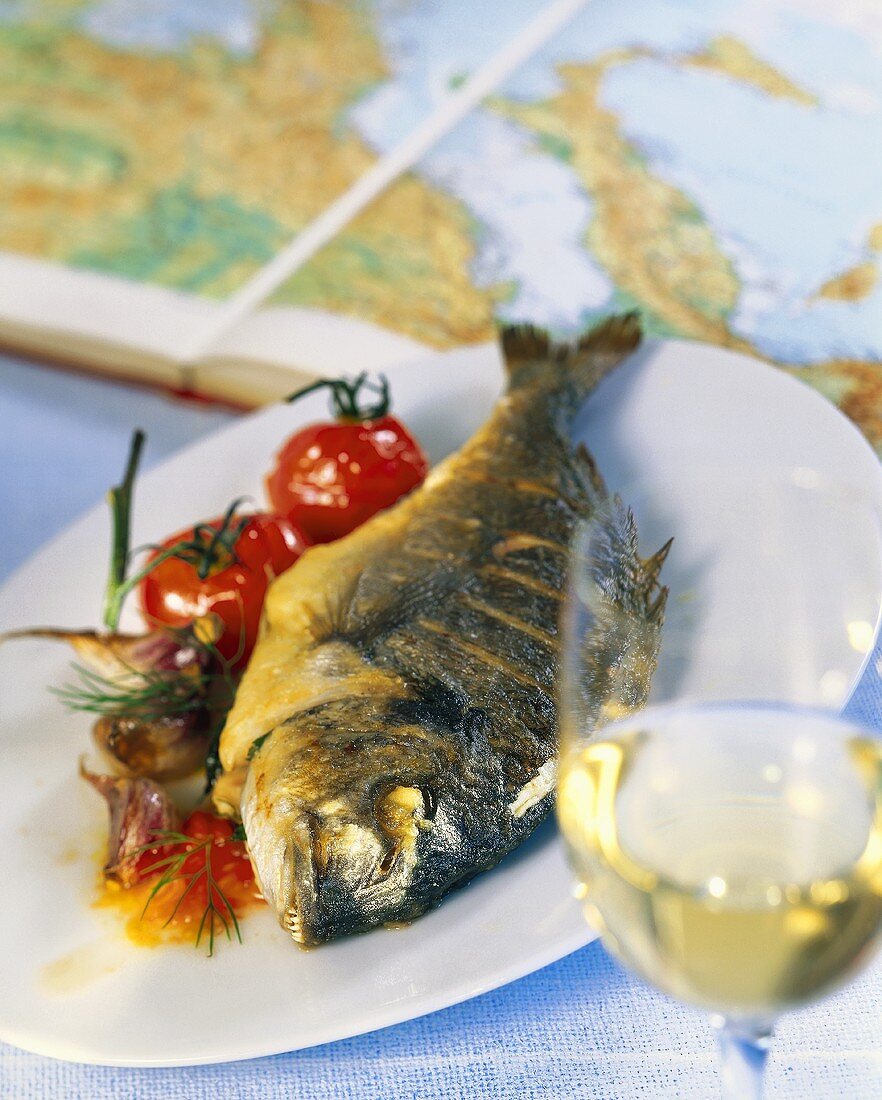 Fried sea bass with tomatoes and garlic