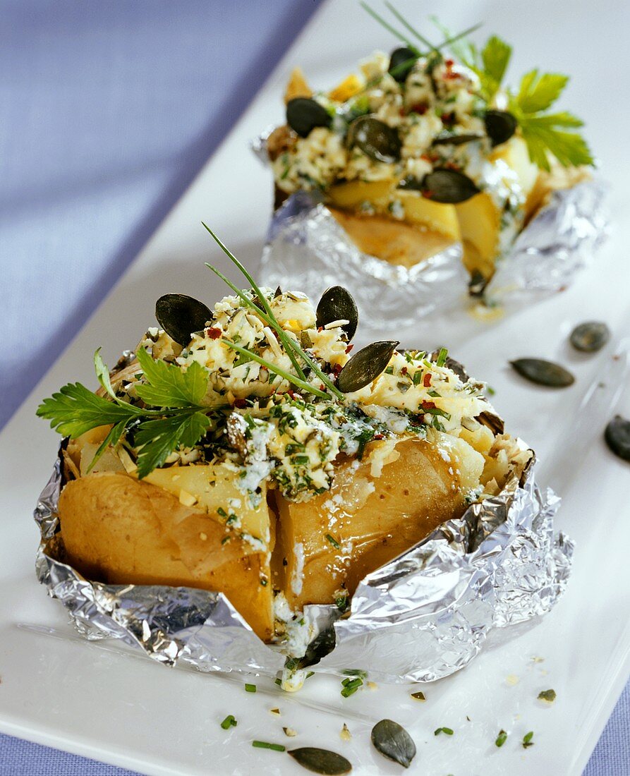 Baked potatoes with herb butter and pumpkin seeds