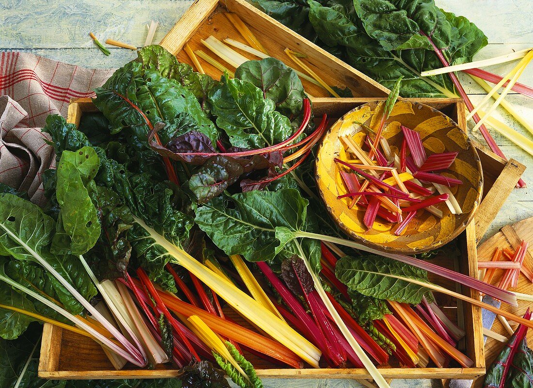 Chard in wooden crates and wooden bowl