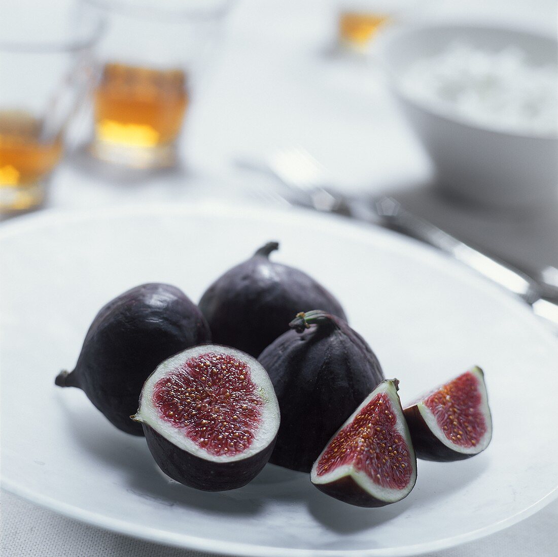 Fresh figs on a plate, one cut open