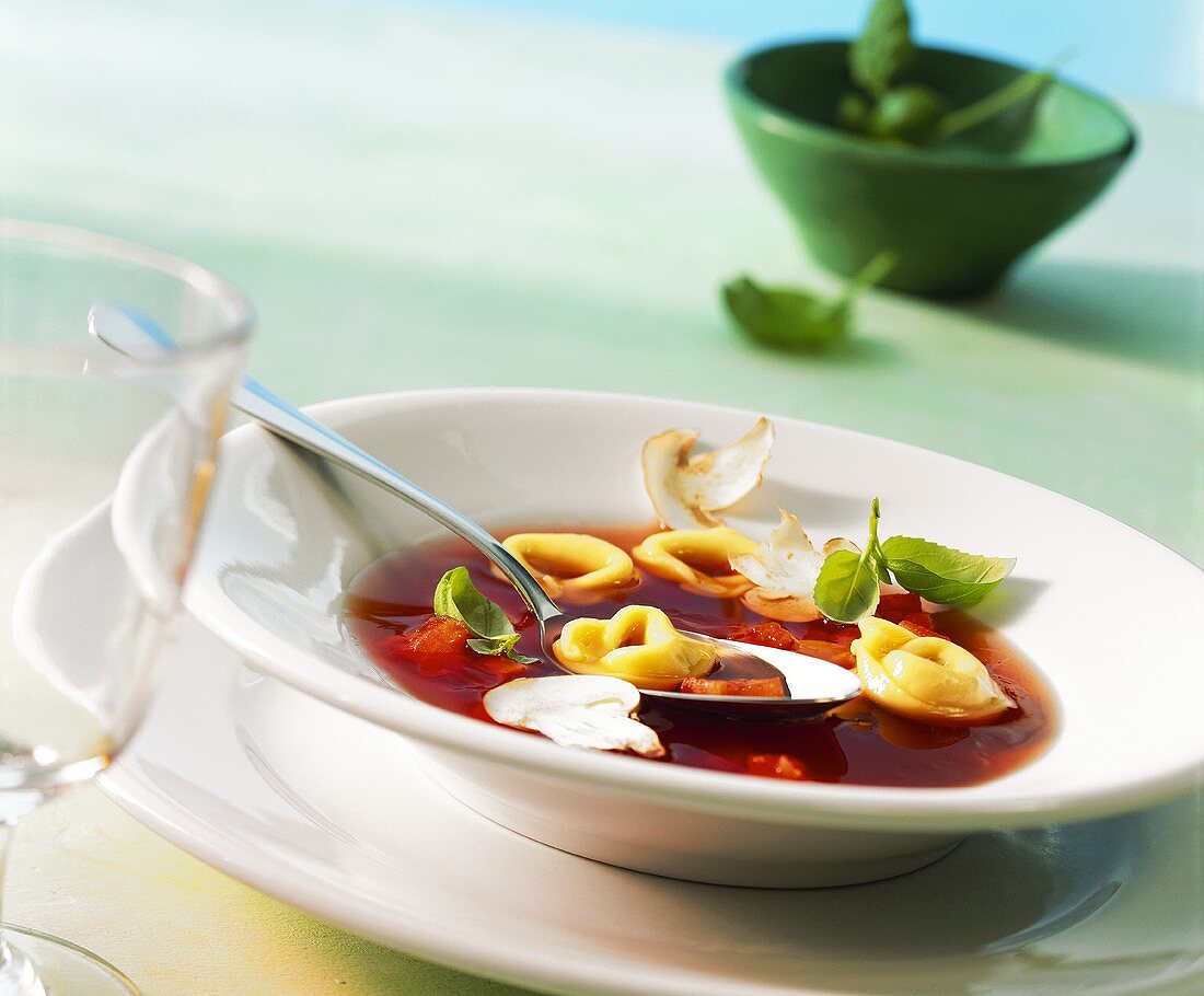 Tomato consomme with tortellini and mushrooms
