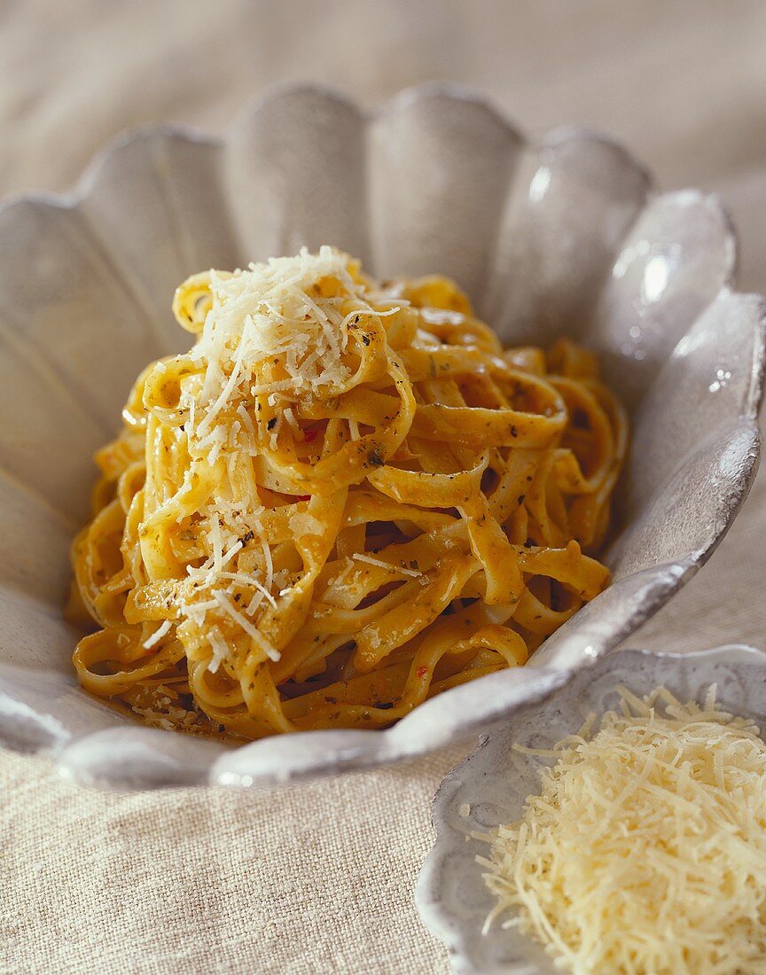 Ribbon noodles with grated cheese in a bowl