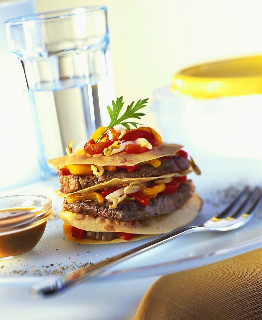 Three Layers of Beef Medallions with Red and Yellow Peppers and Bean Sprouts