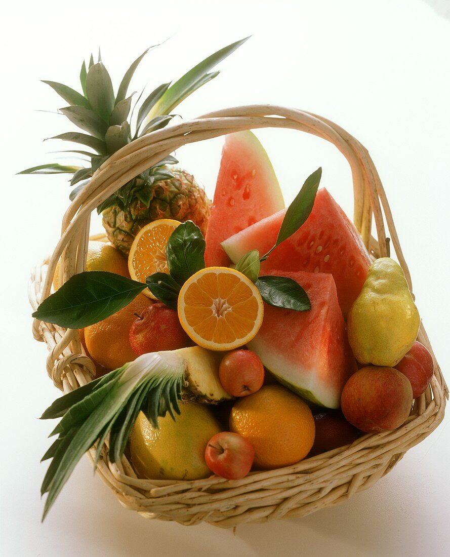 Basket of fruit, whole and cut into