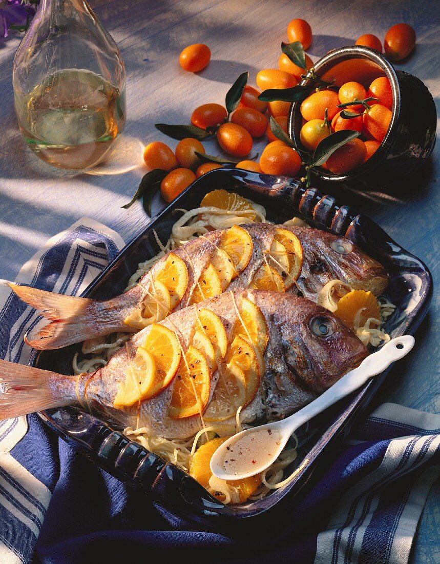 Grilled sea bream with slices of orange
