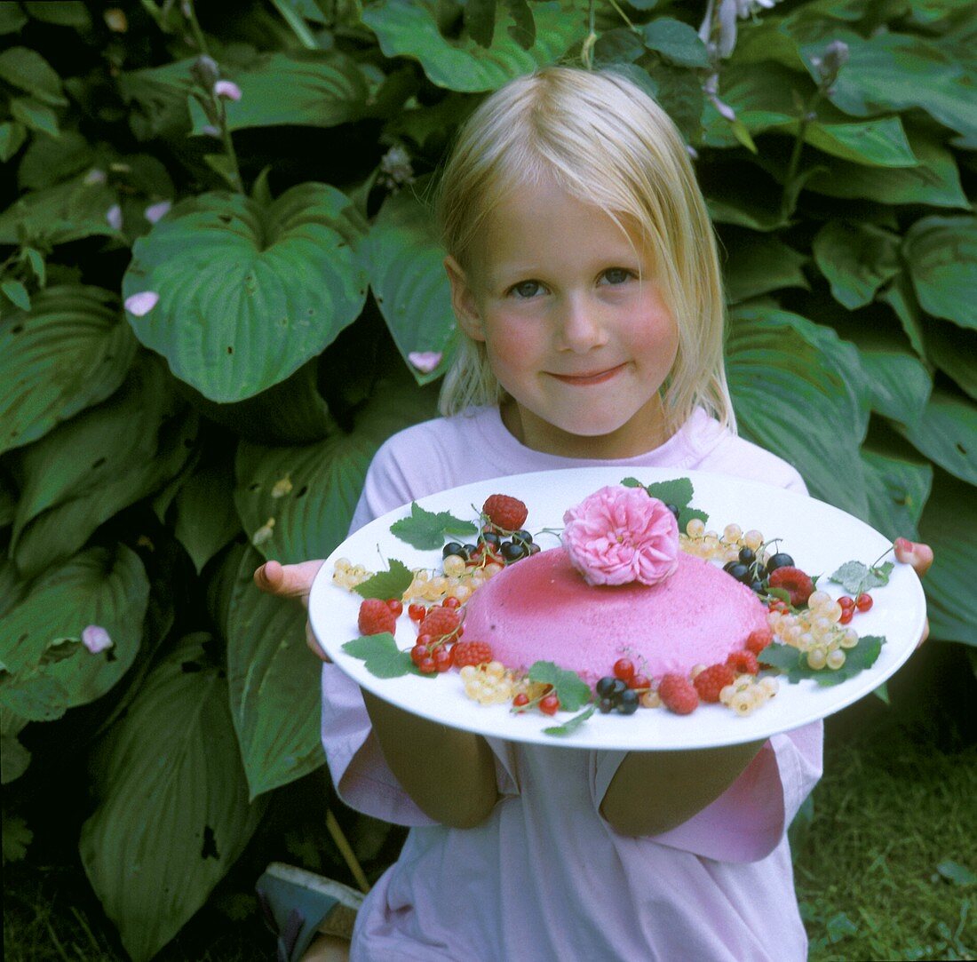 Little Girl Holding a Plate with Raspberry Cream