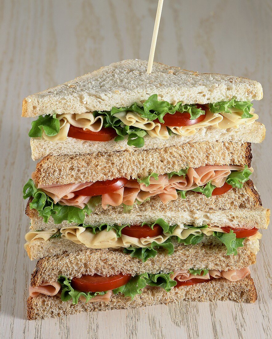 Multi-Layer Sandwich with Ham, Cheese, Tomato and Lettuce