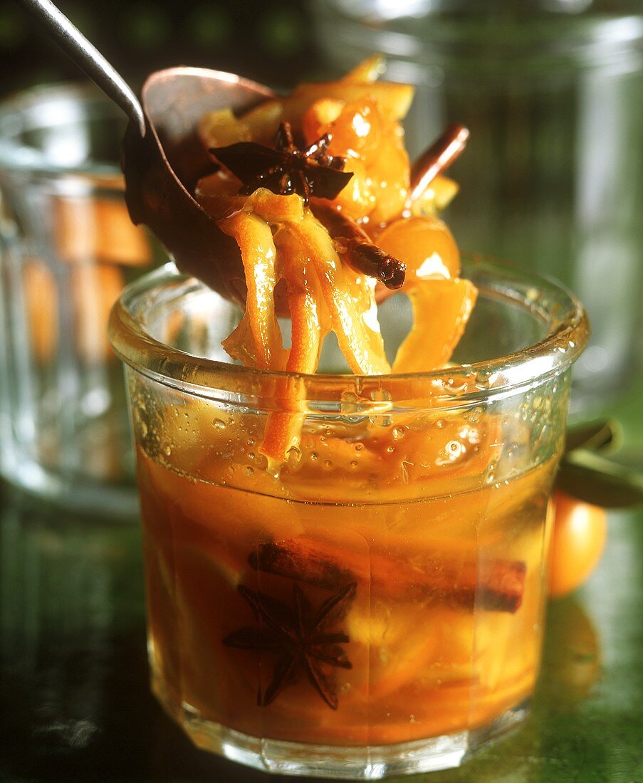 Orange and kumquat jam in a jar and on a spoon