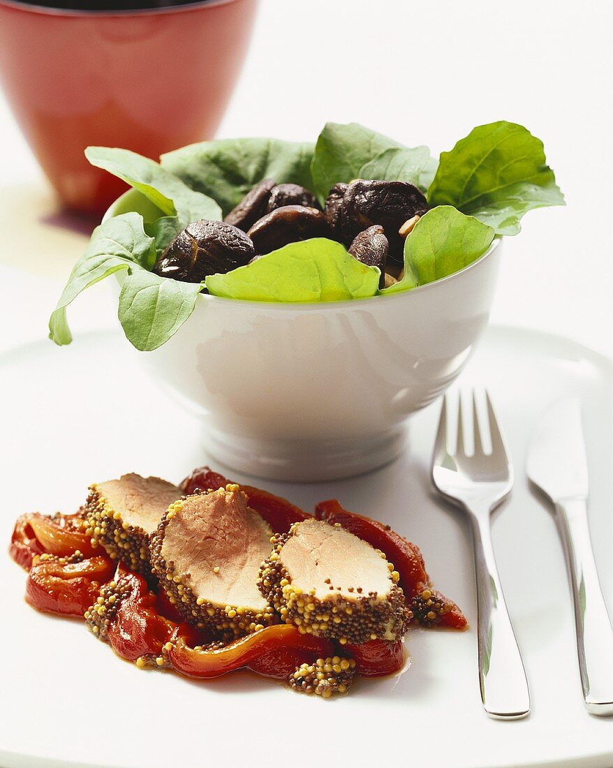 Pork fillet with mustard grains on peppers & mushroom salad