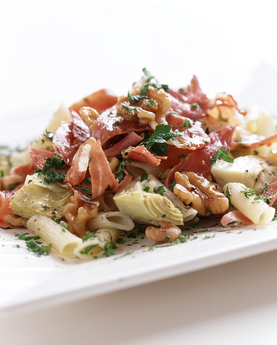 Pasta salad with ham, artichokes and nuts