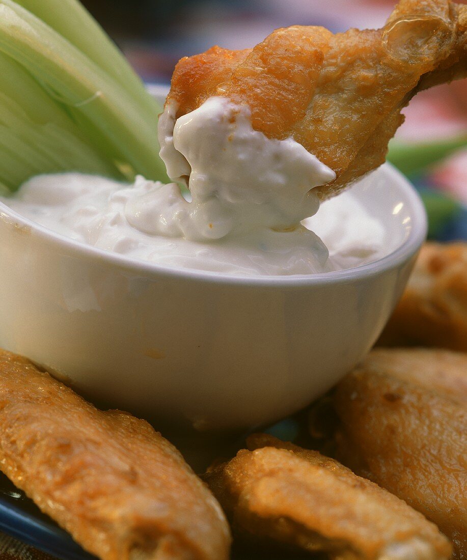 Deep-fried Buffalo chicken wings in cream cheese dip