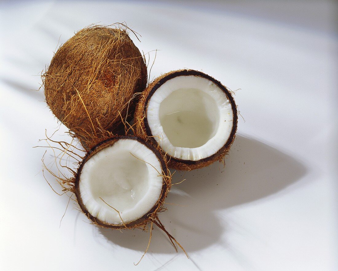 Whole coconut and two coconut halves