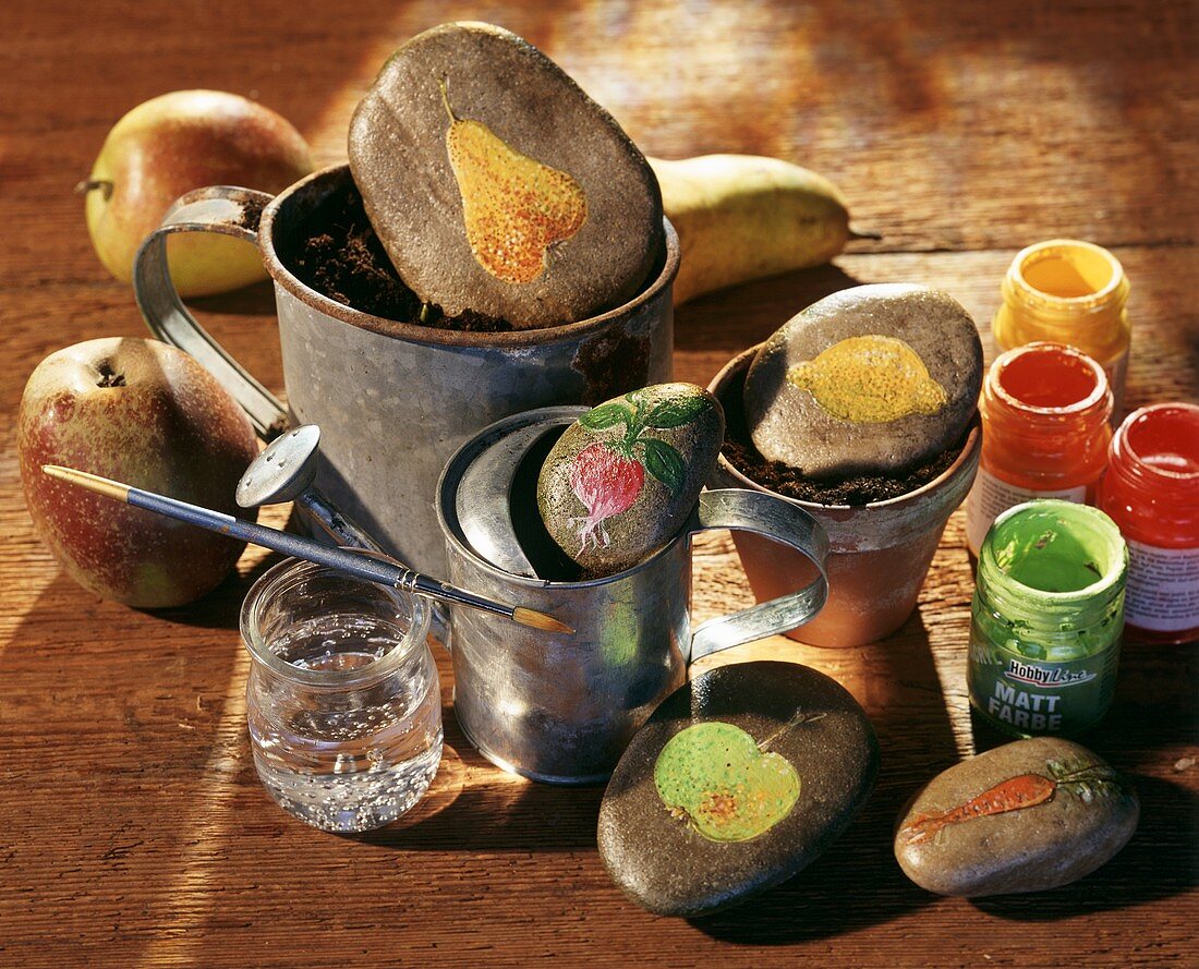 Painted stones with fruit and vegetable motifs