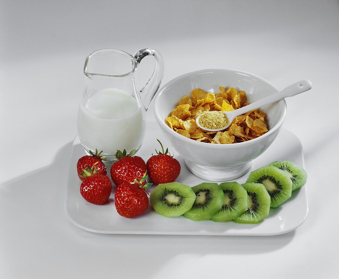 Cornflakes, milk, fresh strawberries and kiwi fruits