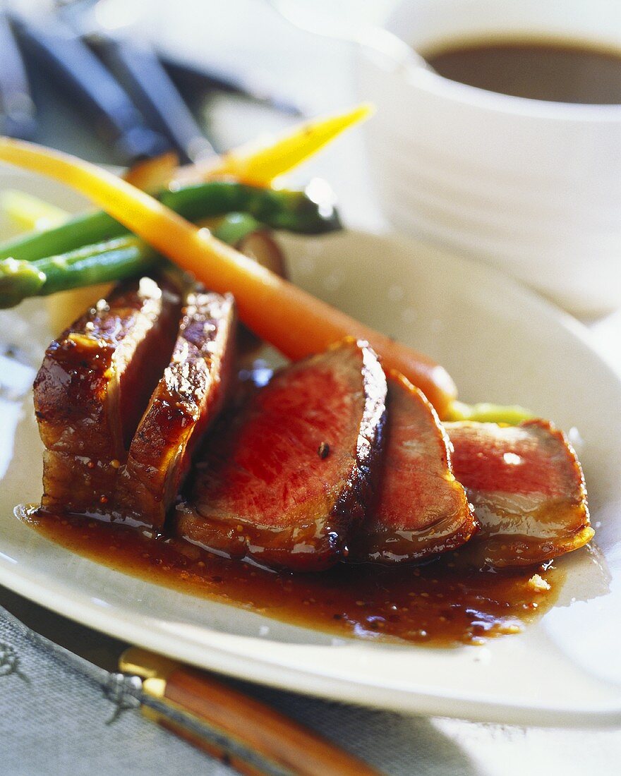 Roast beef with honey sauce and young vegetables