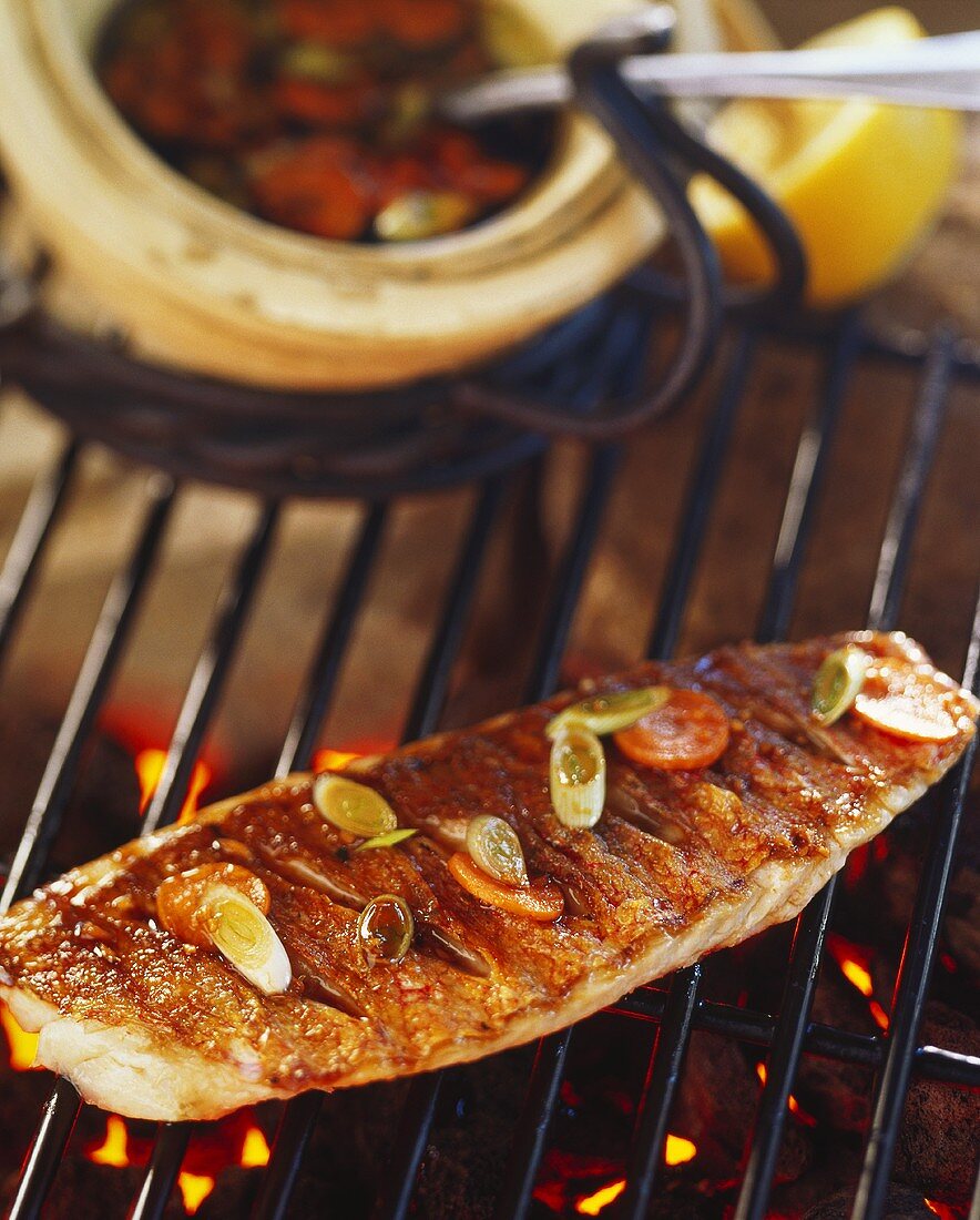 Barbecued sea bream on grill rack