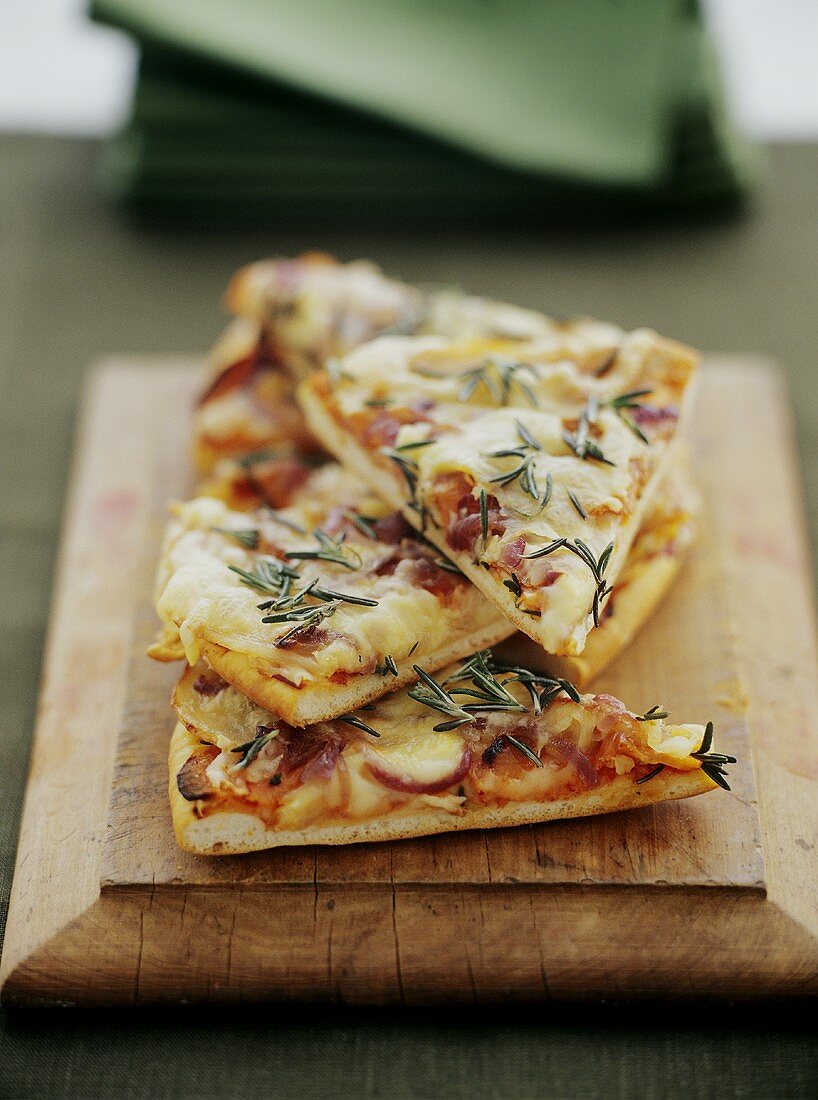 Pieces of pizza with potatoes, onions, cheese and rosemary