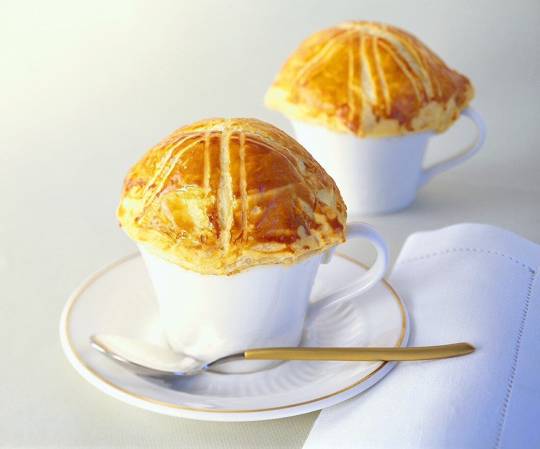 Clear ox-tail soup under puff pastry lid