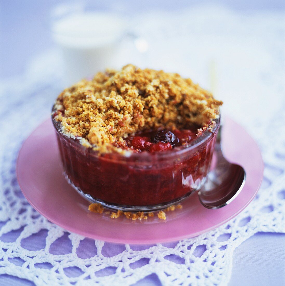 Summer berry crumble in small glass bowl