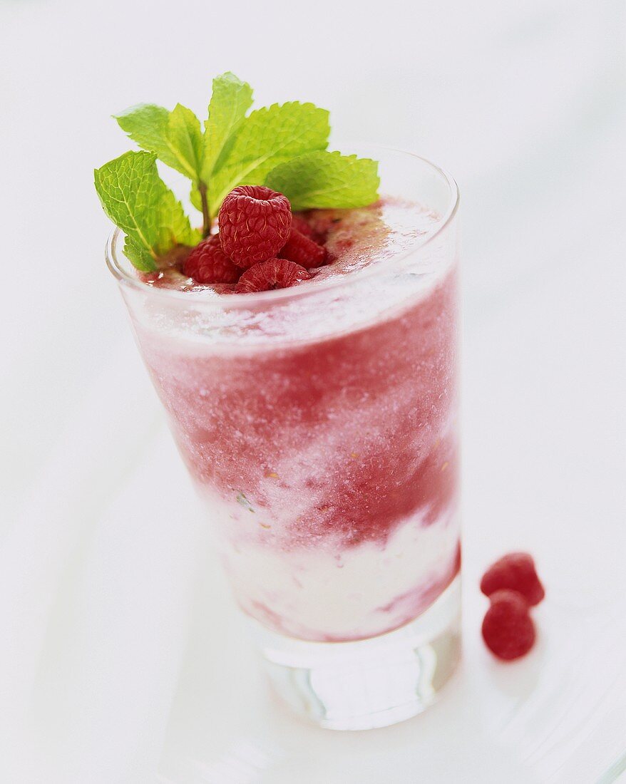 Raspberry smoothie with sprig of mint