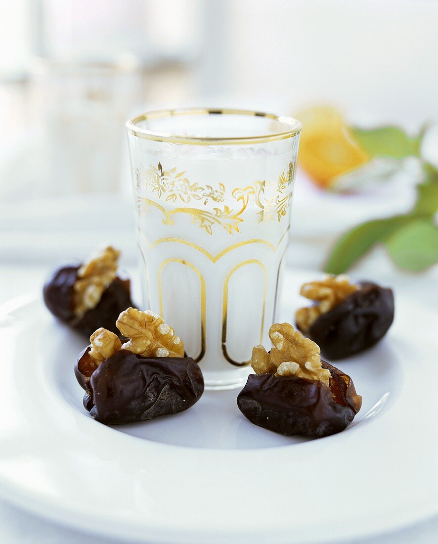 Dates stuffed with walnuts; almond flavoured milk