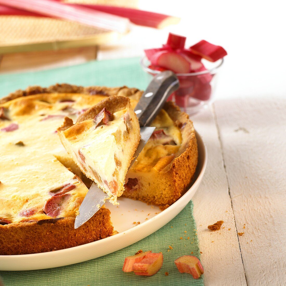 Rhubarb tart, a piece cut, on plate