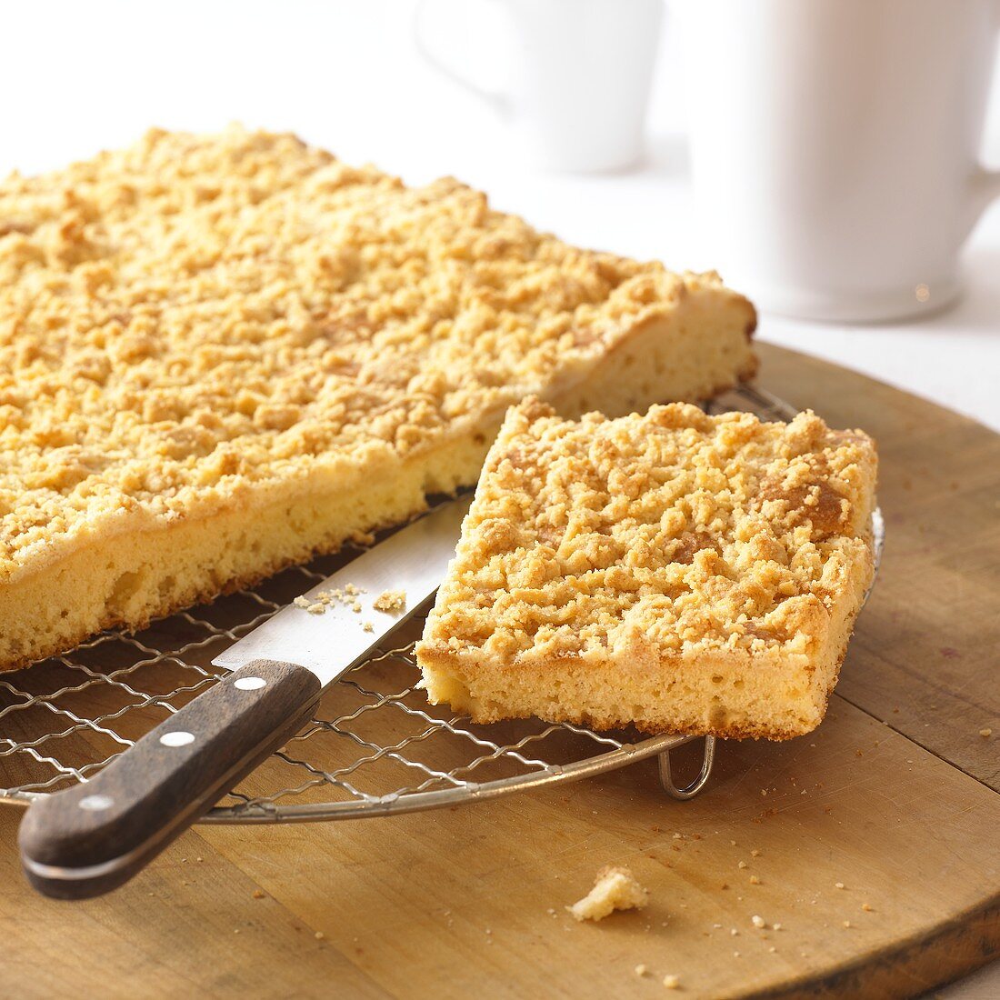 Crumble cake, a piece cut, on cake rack