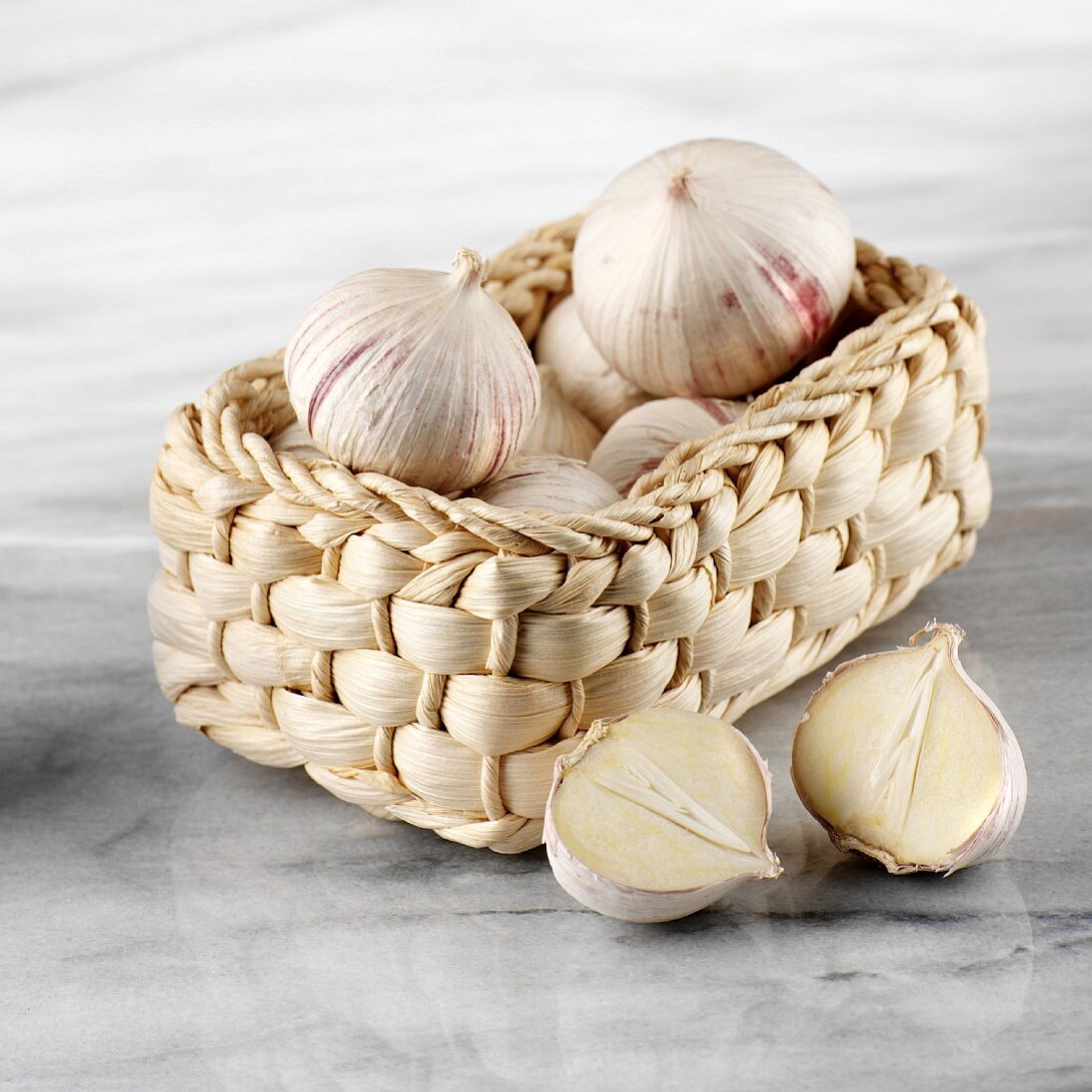 Chinese garlic in basket, one halved
