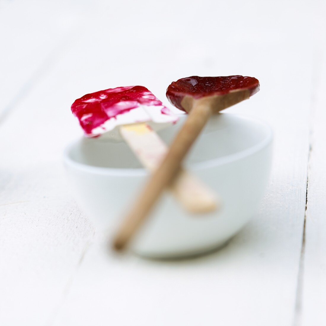 Spatula and kitchen spoon with remains of berry compote