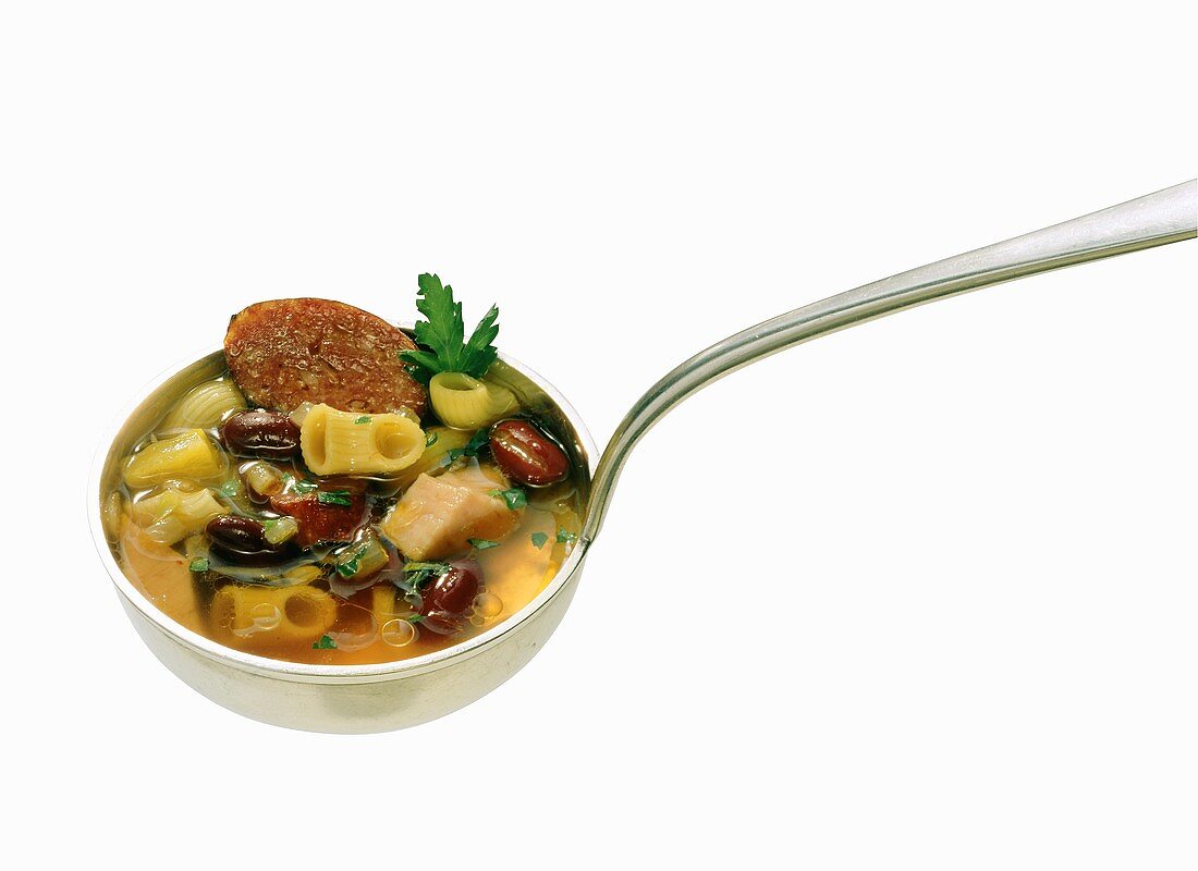 Soup ladle full of pasta and bean stew