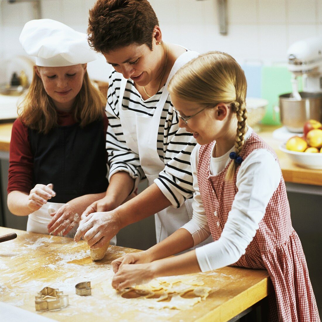 Mother and daughter baking biscuits