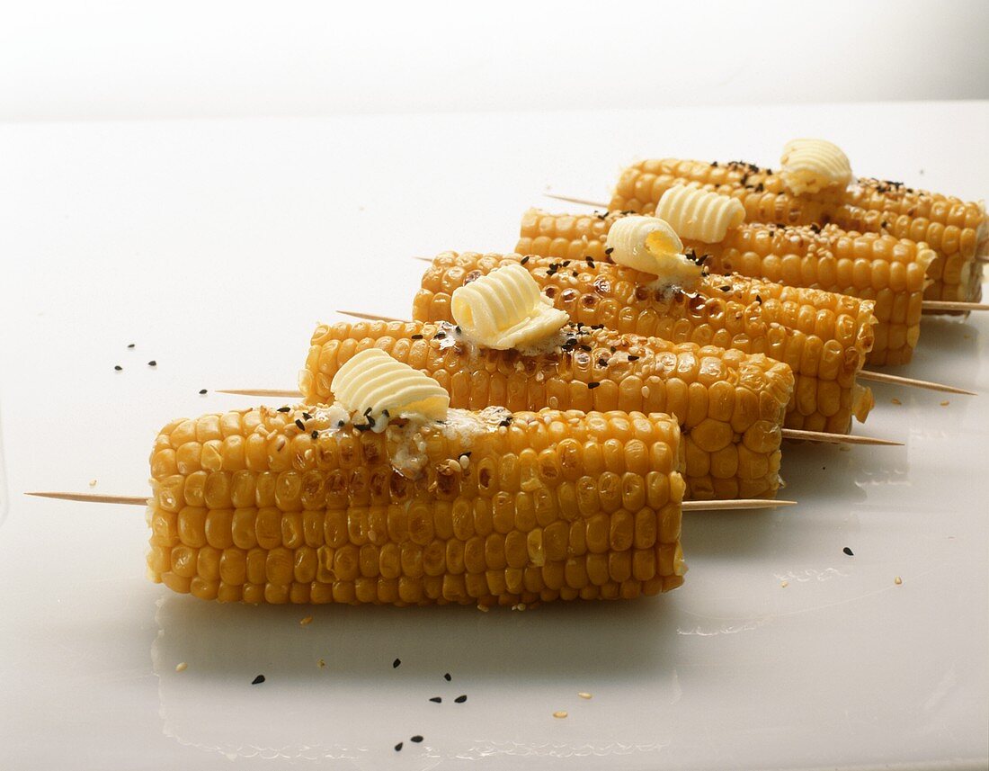 Grilled corn cobs with butter curls