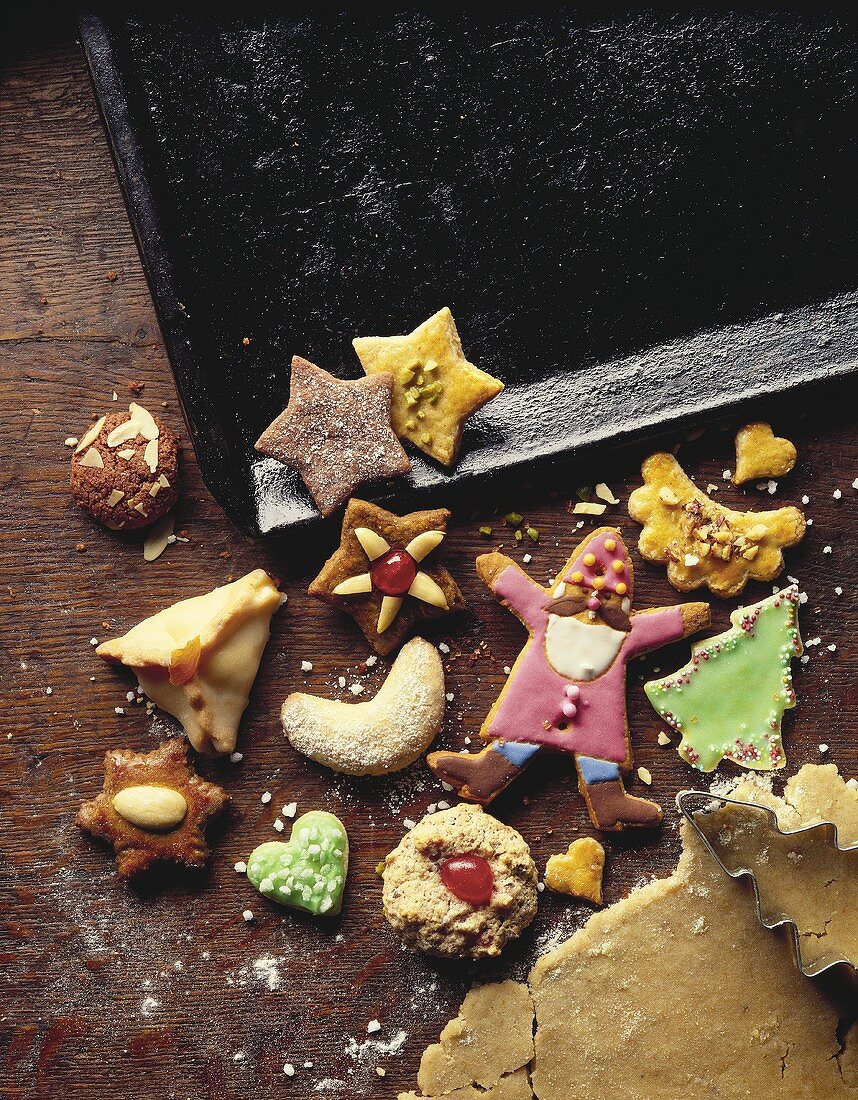 Assorted biscuits, baking sheet and dough with cutter