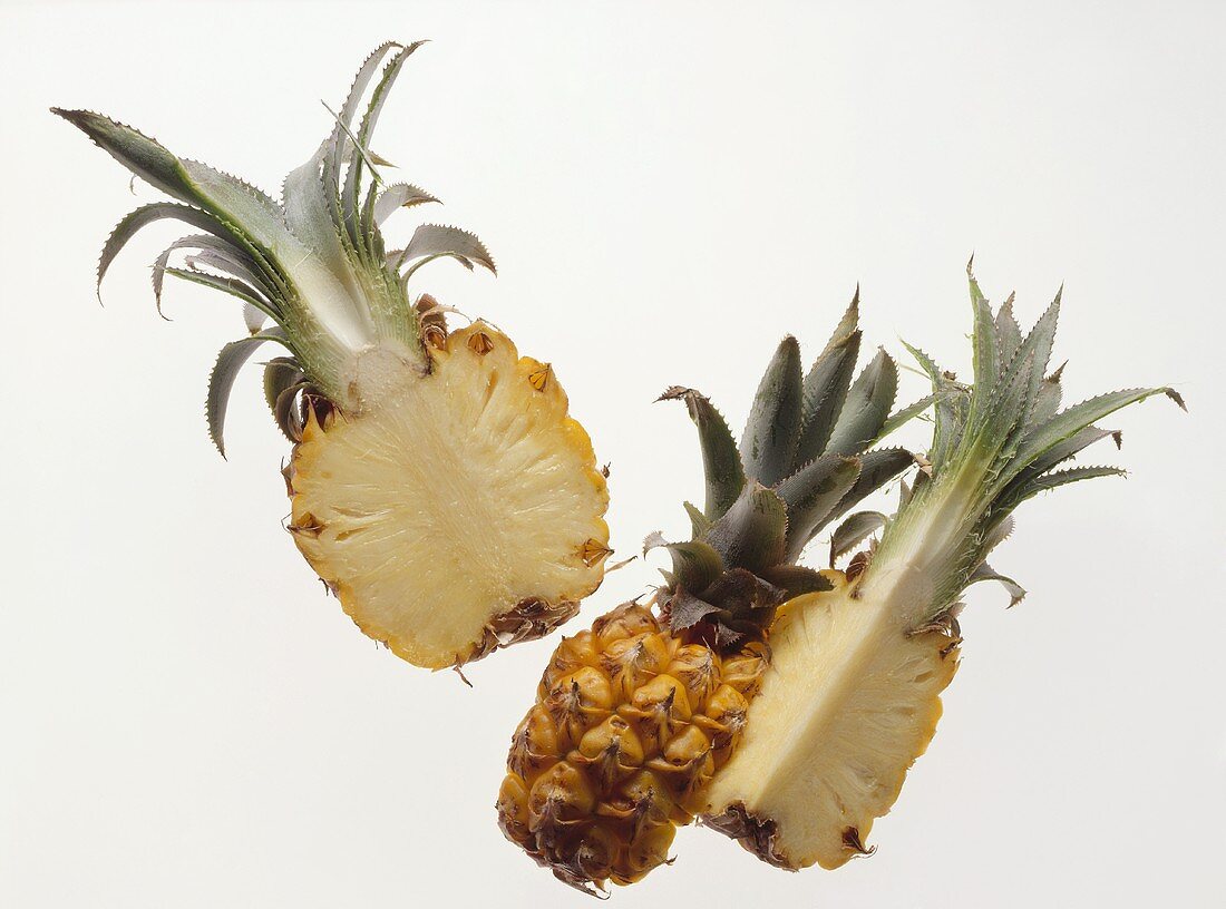 A baby pineapple, cut into three pieces