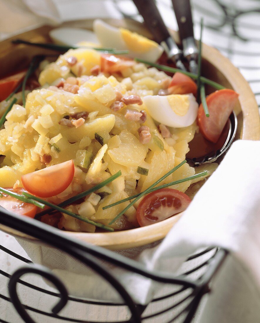 Potato salad with egg and tomato wedges