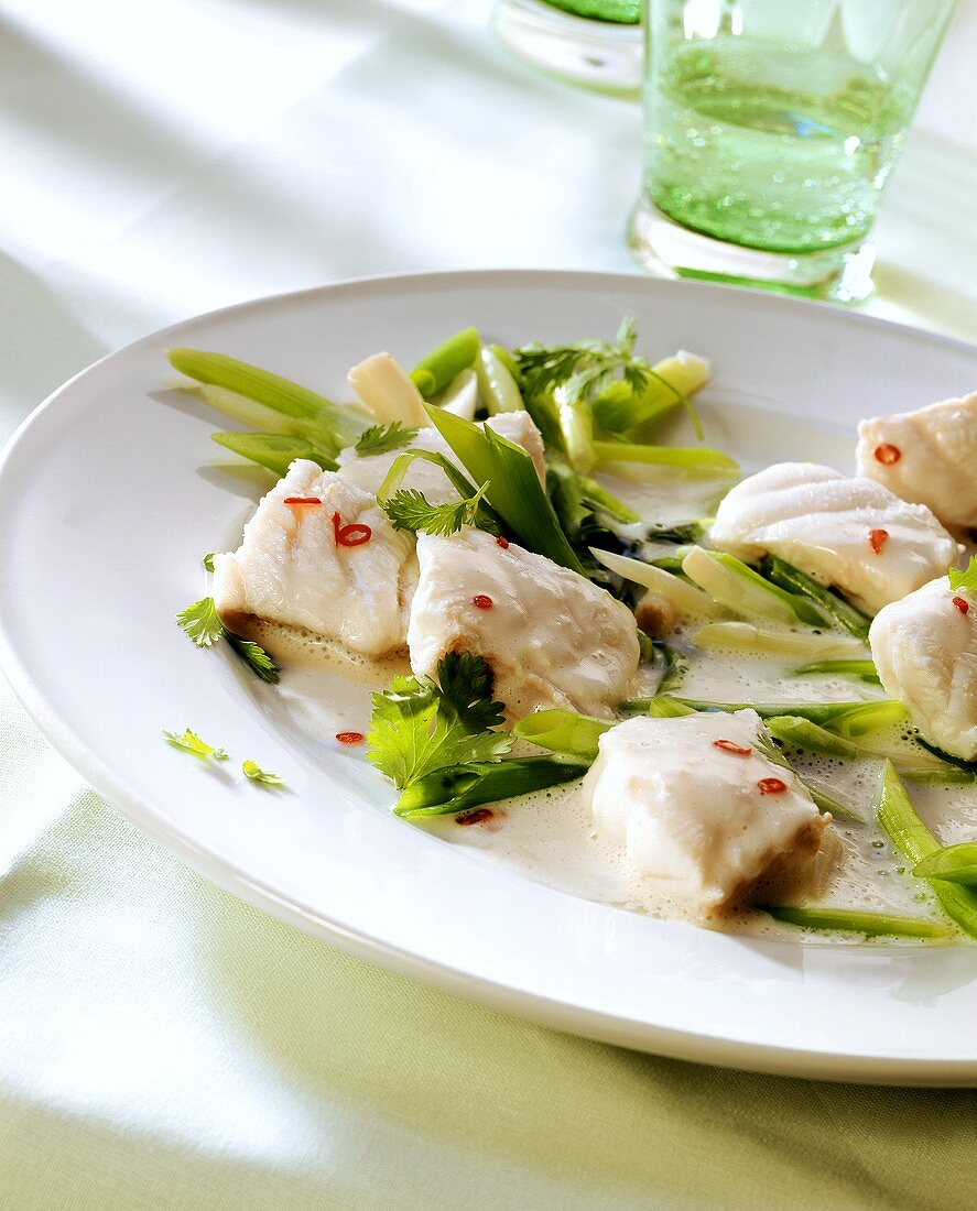 Cod with spring onions in coconut sauce
