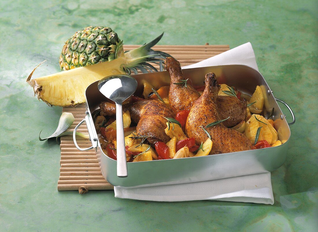 Chicken leg with pineapple in a roasting dish