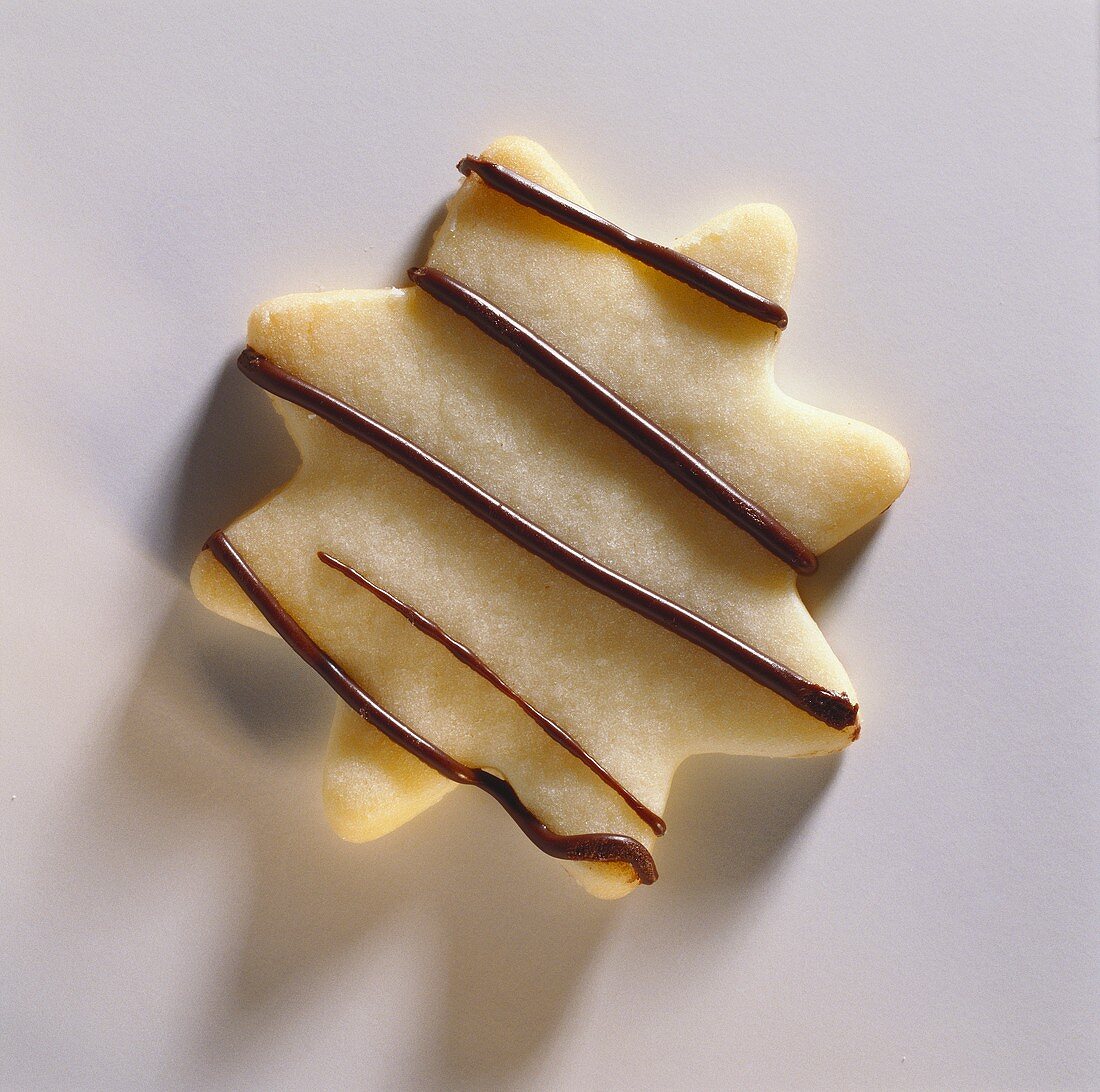 A biscuit decorated with chocolate stripes