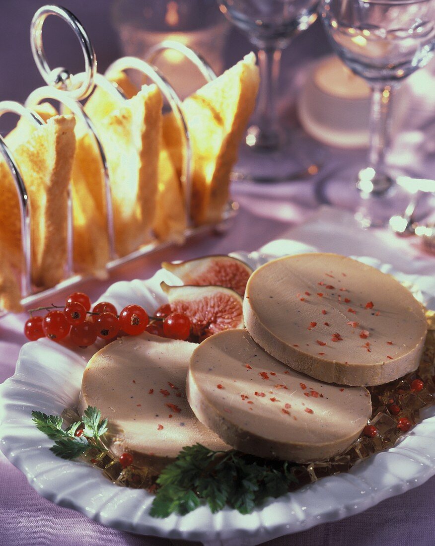 Three slices of goose liver pate on plate